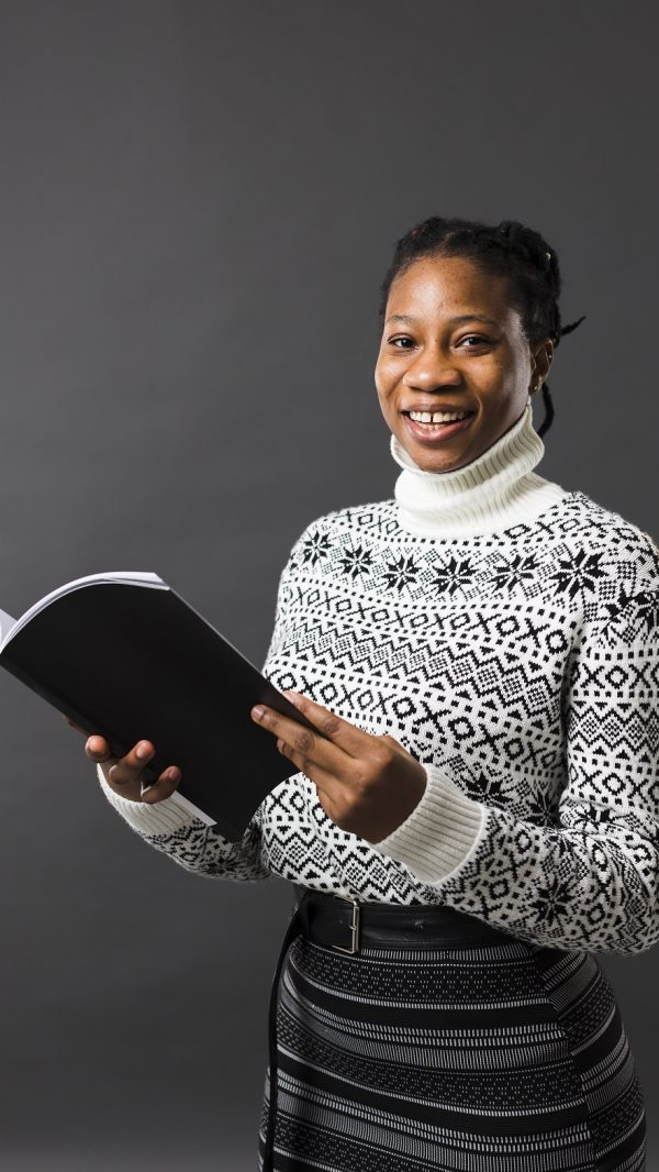 afroamerican-model-holding-book-medium-shot